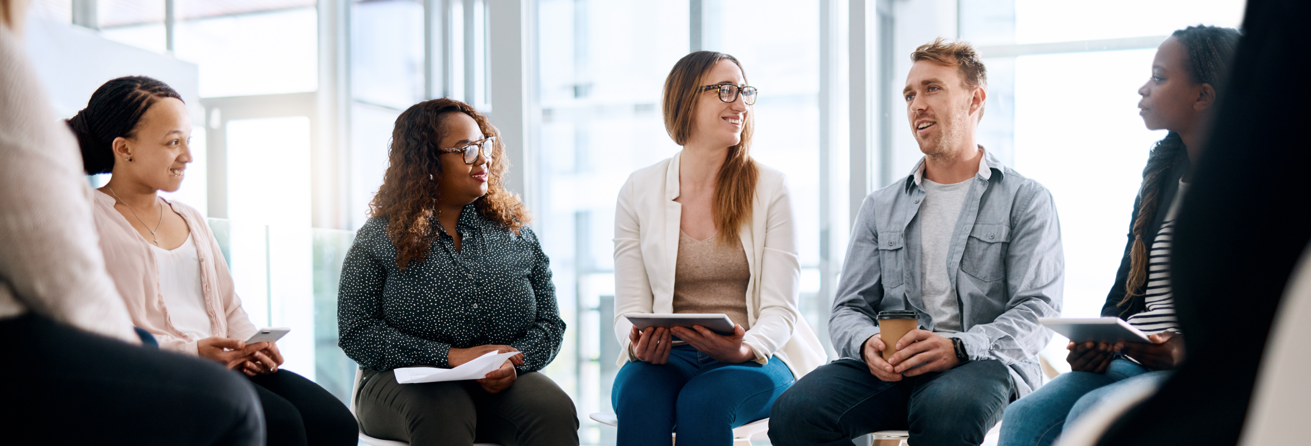 People sitting in support group smiling